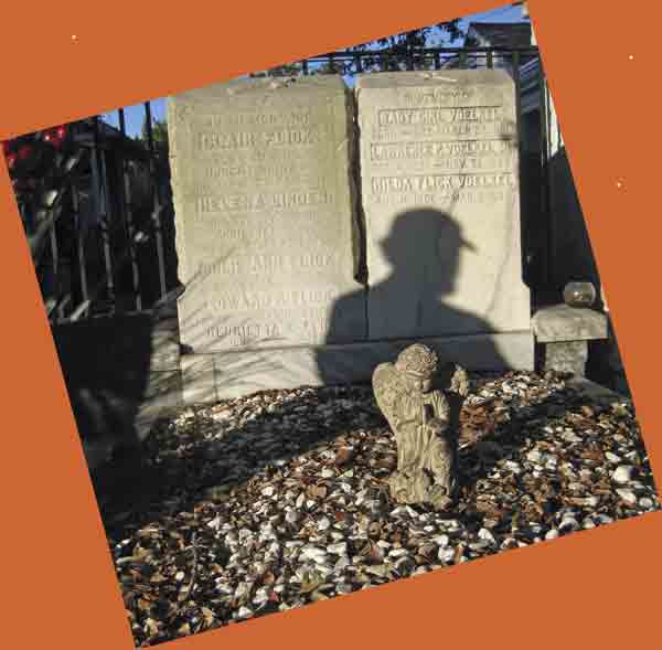 new-orleans-grave-and-shado I took this photo of a burial plot in New Orleans with shadow of a man and small statue of an angel.