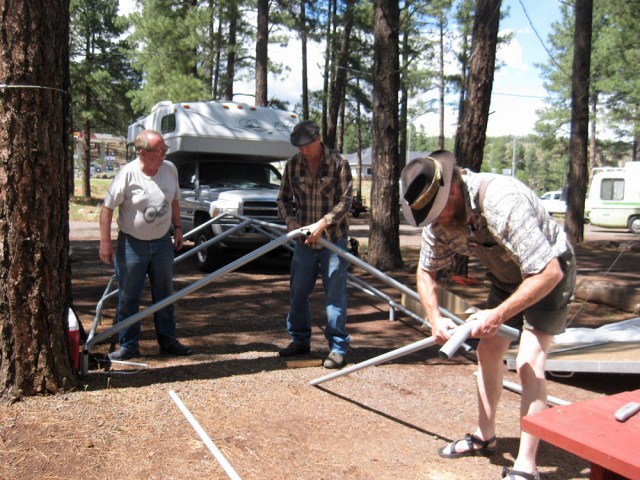 Jeff S., Jeff W, and Fred erect the new shelter