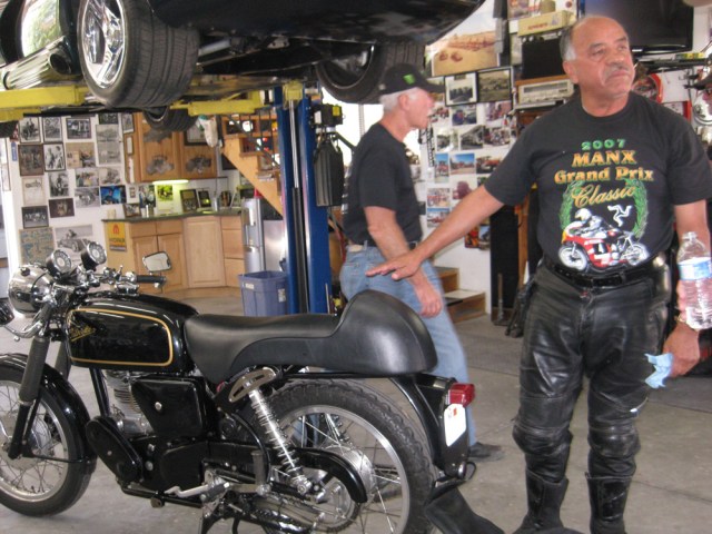 Frank's-laying-on-hands Frank attempts to adjust the bike's aura