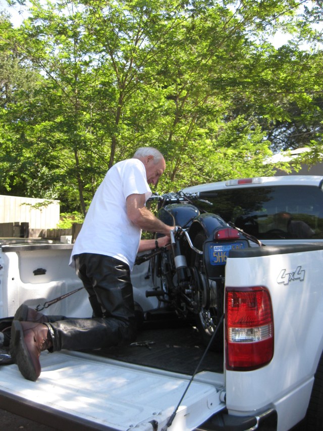 Don worked on his bike in the back of the chase truck
