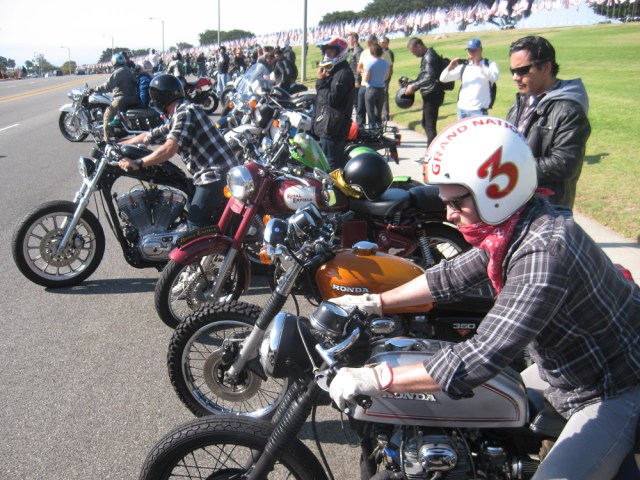 Bikes line up in front of the flags at Pepperdine